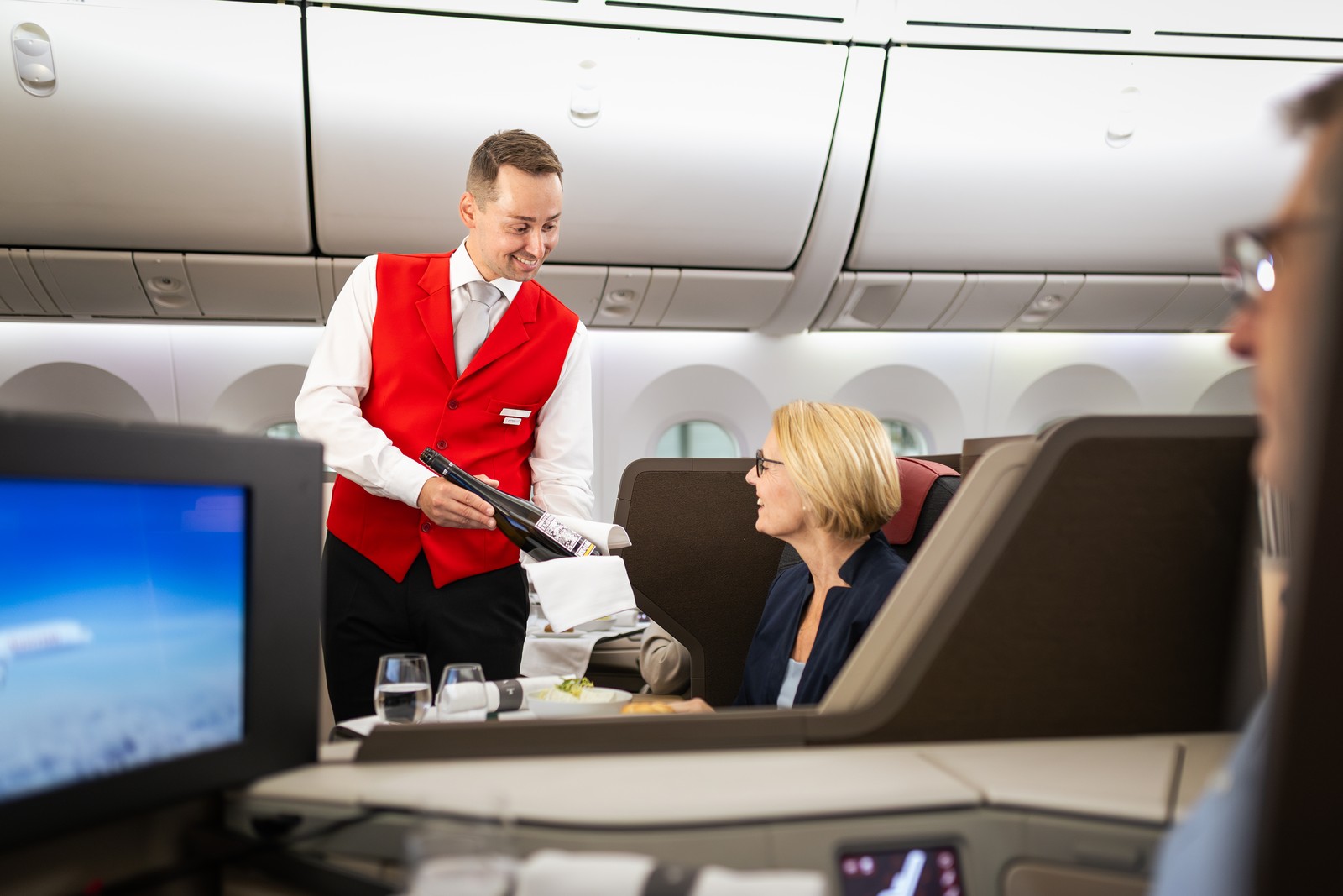 Wine service for Business Class passengers on the Austrian Airlines Boeing 787 Dreamliner. Photo by Austrian Airlines.