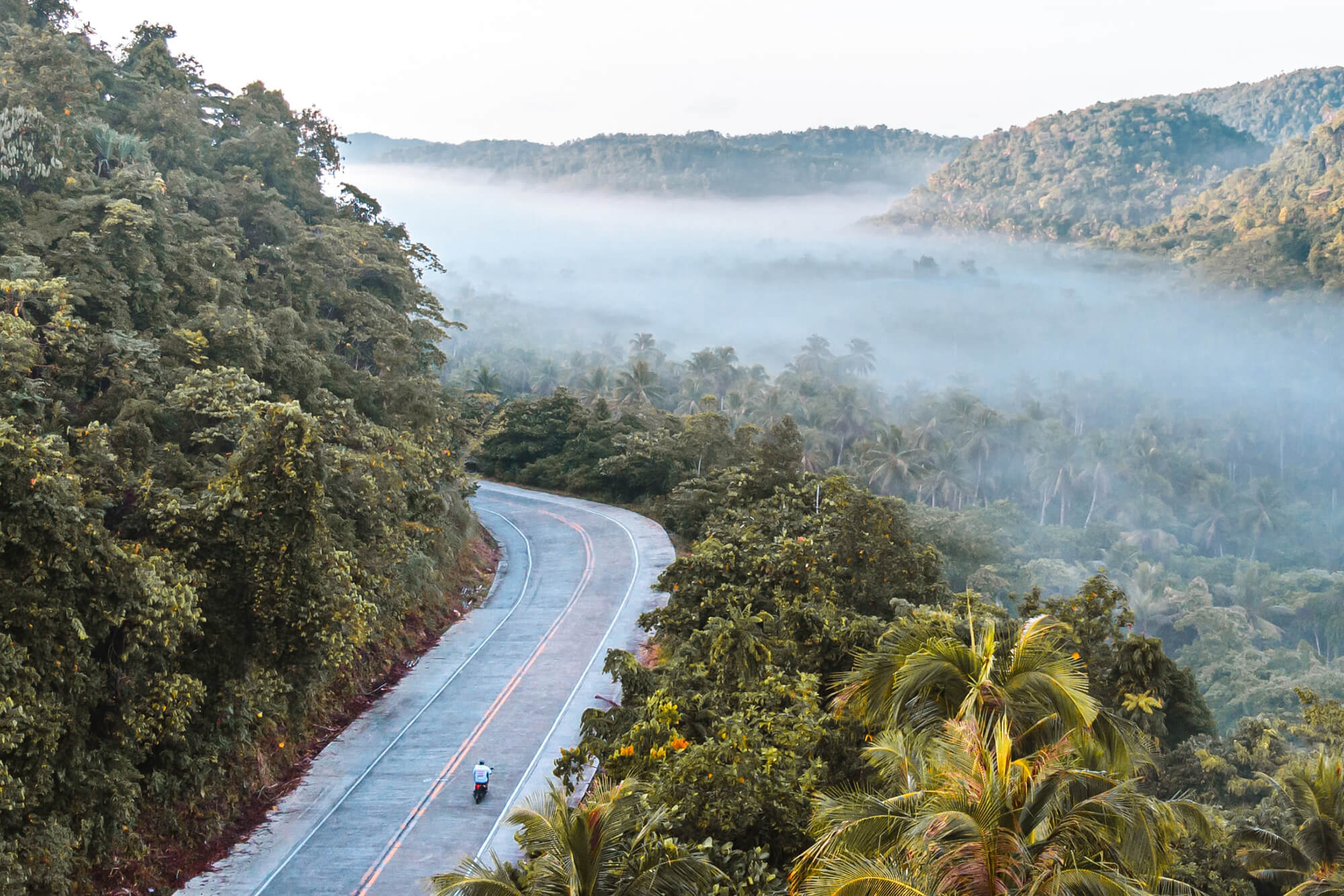 Riding a motorbike on the roads of Siargao island, Philippines. Photo by Alejandro Luengo.