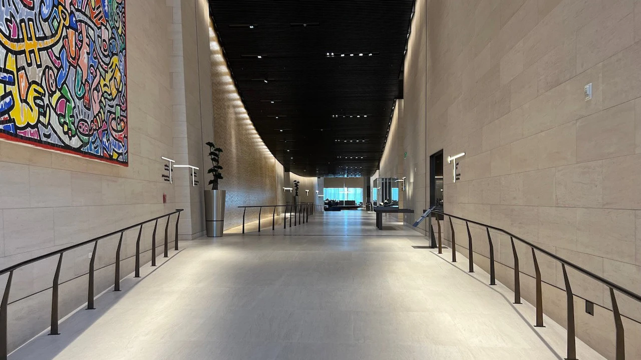 Qatar Airways Al Safwa First Lounge grand hall with sandstone walls and artwork in Doha