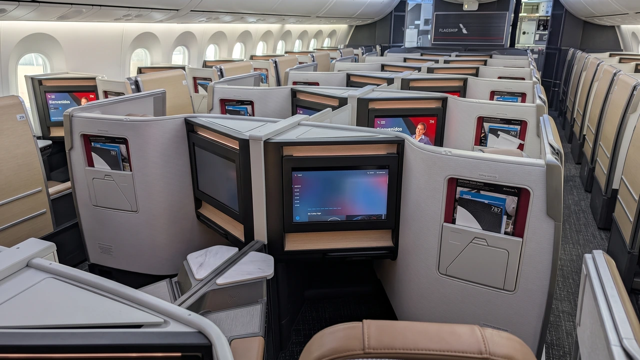 American Airlines Boeing 787-9P Flagship Suite cabin with sliding privacy doors and wood-grain trim