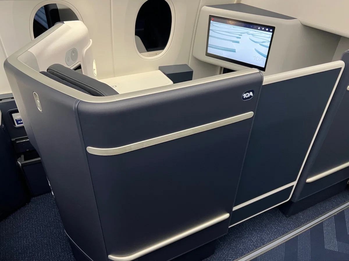 Air France business class reverse herringbone suite with signature navy blue and red stitching