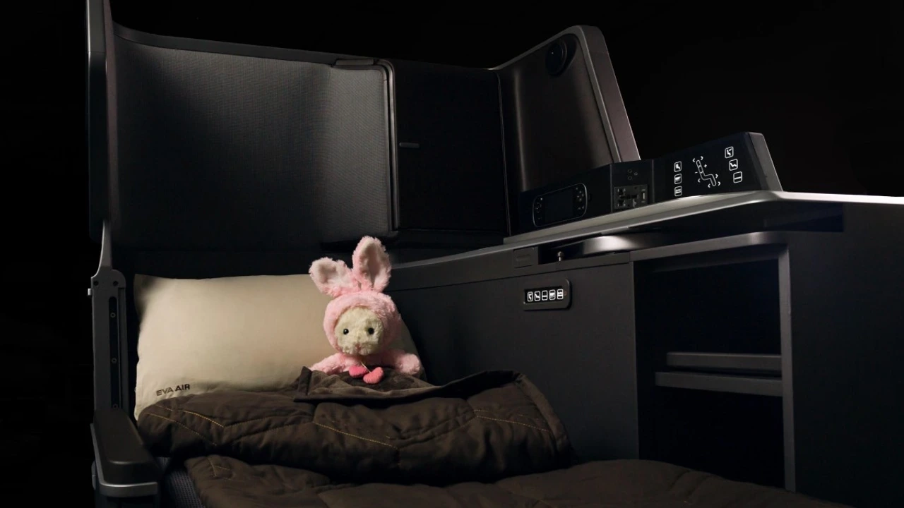 EVA Air Royal Laurel seat converted to a flat bed with duvet and pillow, side console with seat controls