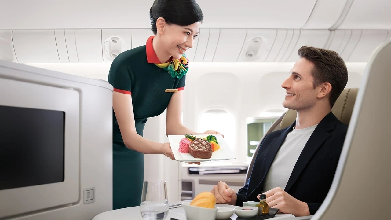 EVA Air Royal Laurel flight attendant serving pan-seared beef tenderloin